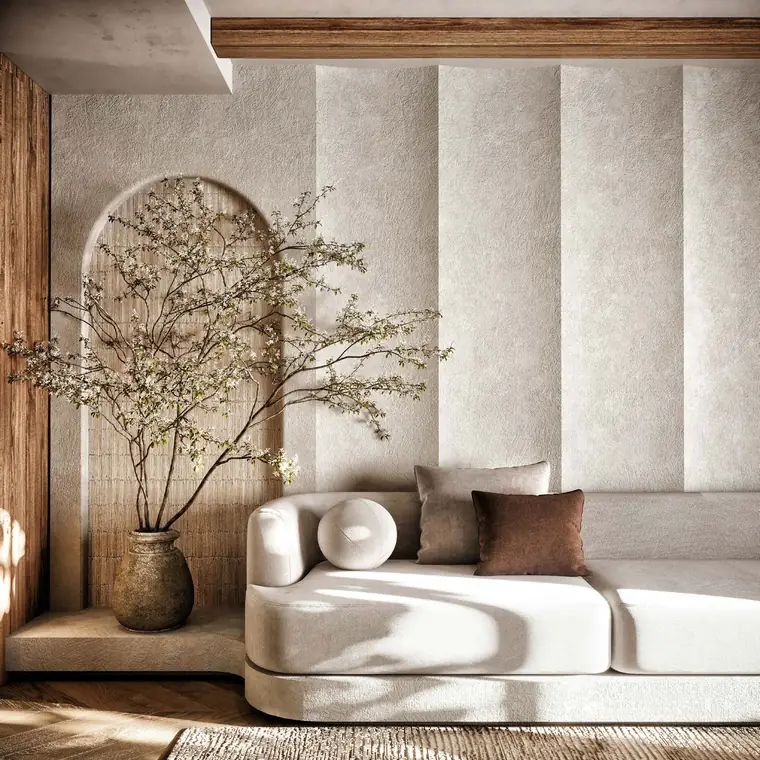 Textured plaster arches with blossom branches and a curved sofa